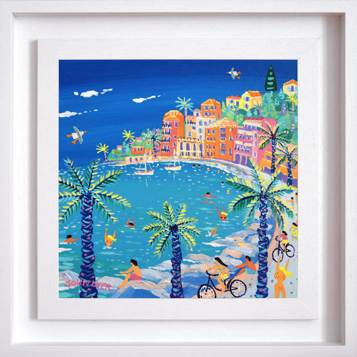 Framed artwork of a colorful coastal scene with buildings, palm trees, and people. 'Cycling by the Bay, Villefranche-sur-Mer'. 12 x 12 inches acrylic on canvas. Painting of the South of France by John Dyer