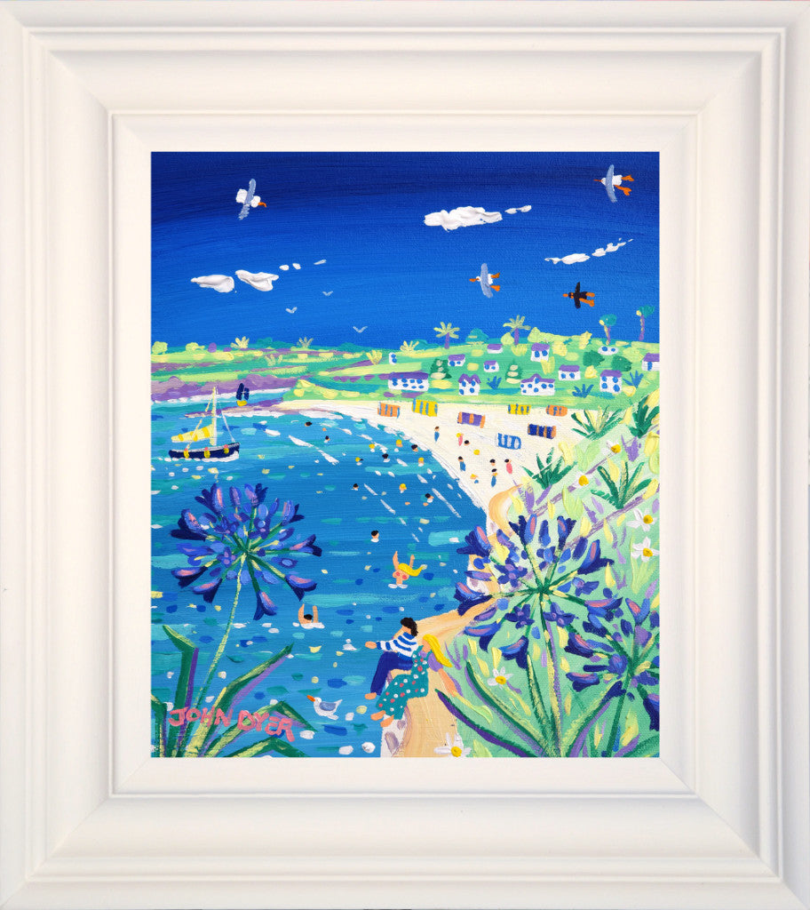 A delightful new painting by artist John Dyer featuring Gyllyngvase Beach in Falmouth. Relaxing blues, aquas combine on the canvas to describe the clear inviting water and the beautiful blue agapanthus flowers. A couple sit on the sea wall looking out to see and bathers, seagulls and sailing boats complete this idyllic scene.