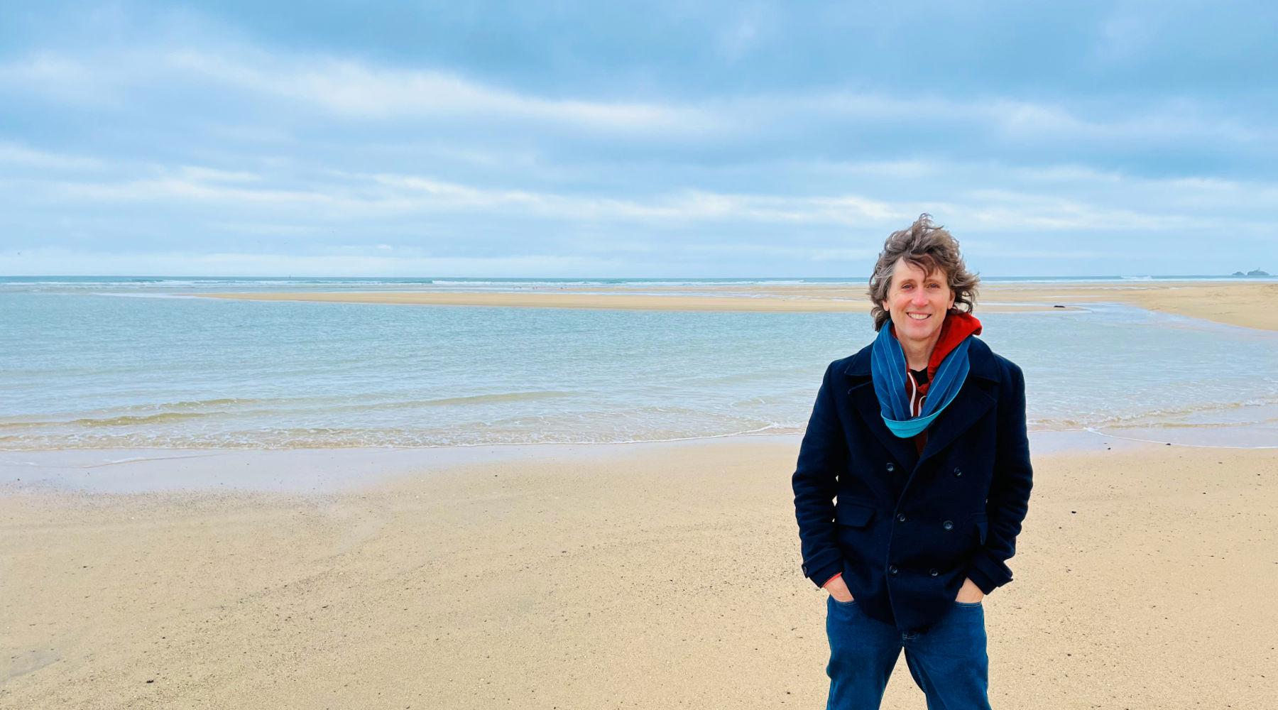 Artist John Dyer standing on the beach at Hayle, Gwithian Sands in Cornwall