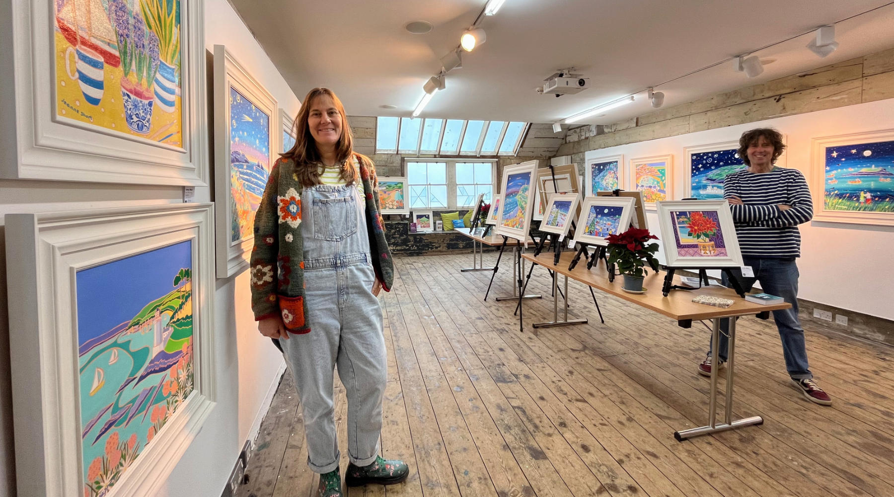 A selection of paintings in an exhibition by the John Dyer Gallery - one of Cornwall's leading artwork galleries. Cornish artists Joanne Short and John Dyer pictured in the Porthmeor Studios at St Ives in Cornwall