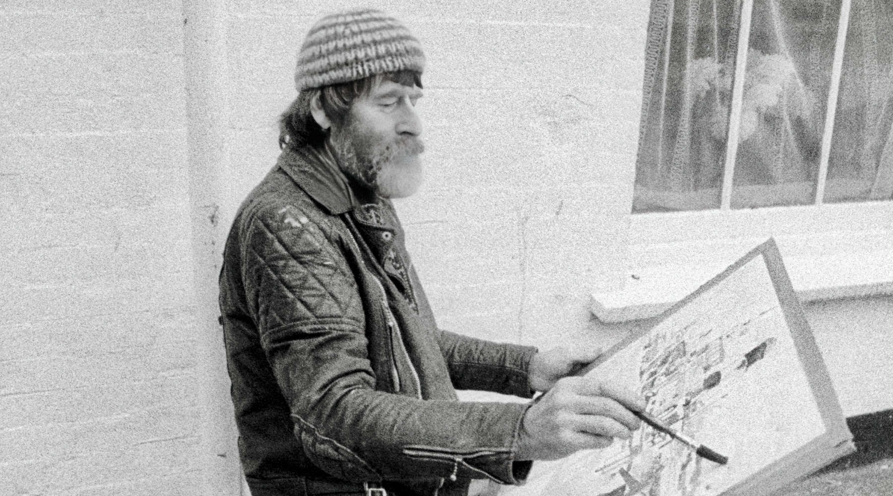 Cornish artist Fred Yates painting a watercolour in Falmouth. Photograph by artist John Dyer