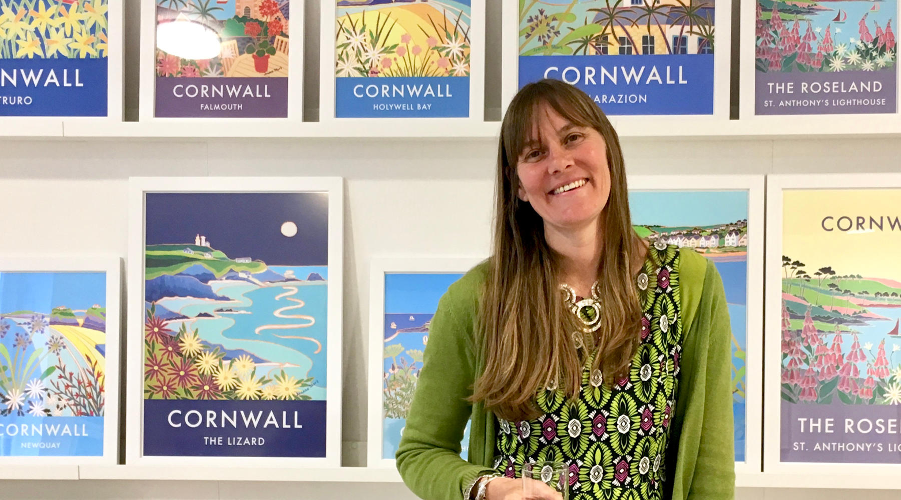 Artist Joanne Short pictured with her framed art poster prints of Cornwall