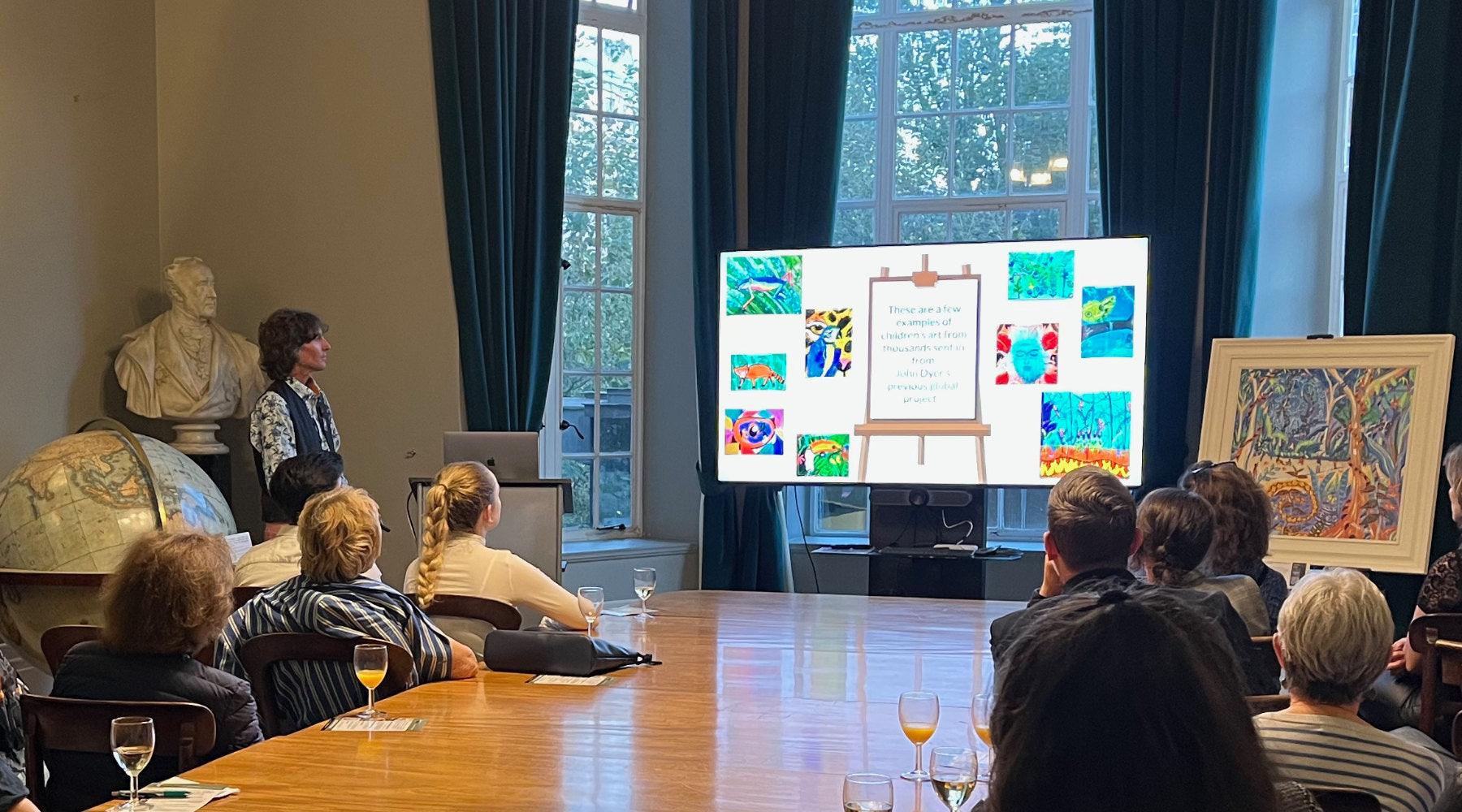 Artist John Dyer (standing on the far left) presenting a keynote on environmental art and the Last Chance to Paint initiative in the Council Room of the Royal Geographical Society (RGS) in London in September 2023.