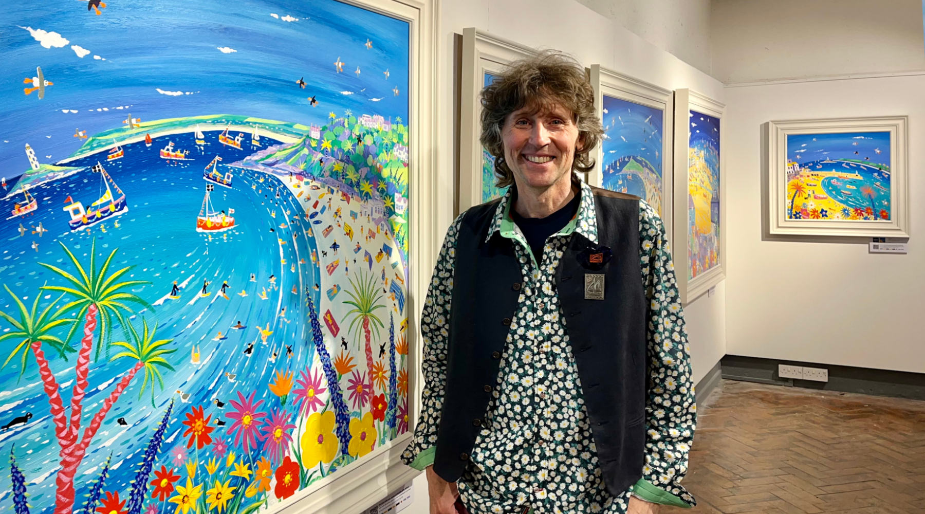 Cornwall artist John Dyer pictured with his painting of the seaside exhibited at the St Ives Society of Artists Crypt Gallery in St Ives in Cornwall.
