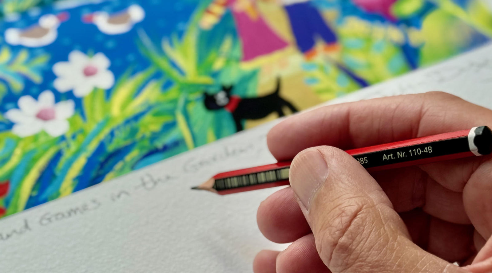 Cornish artist John Dyer signing a limited edition fine art print with a pencil in his studio in Cornwall