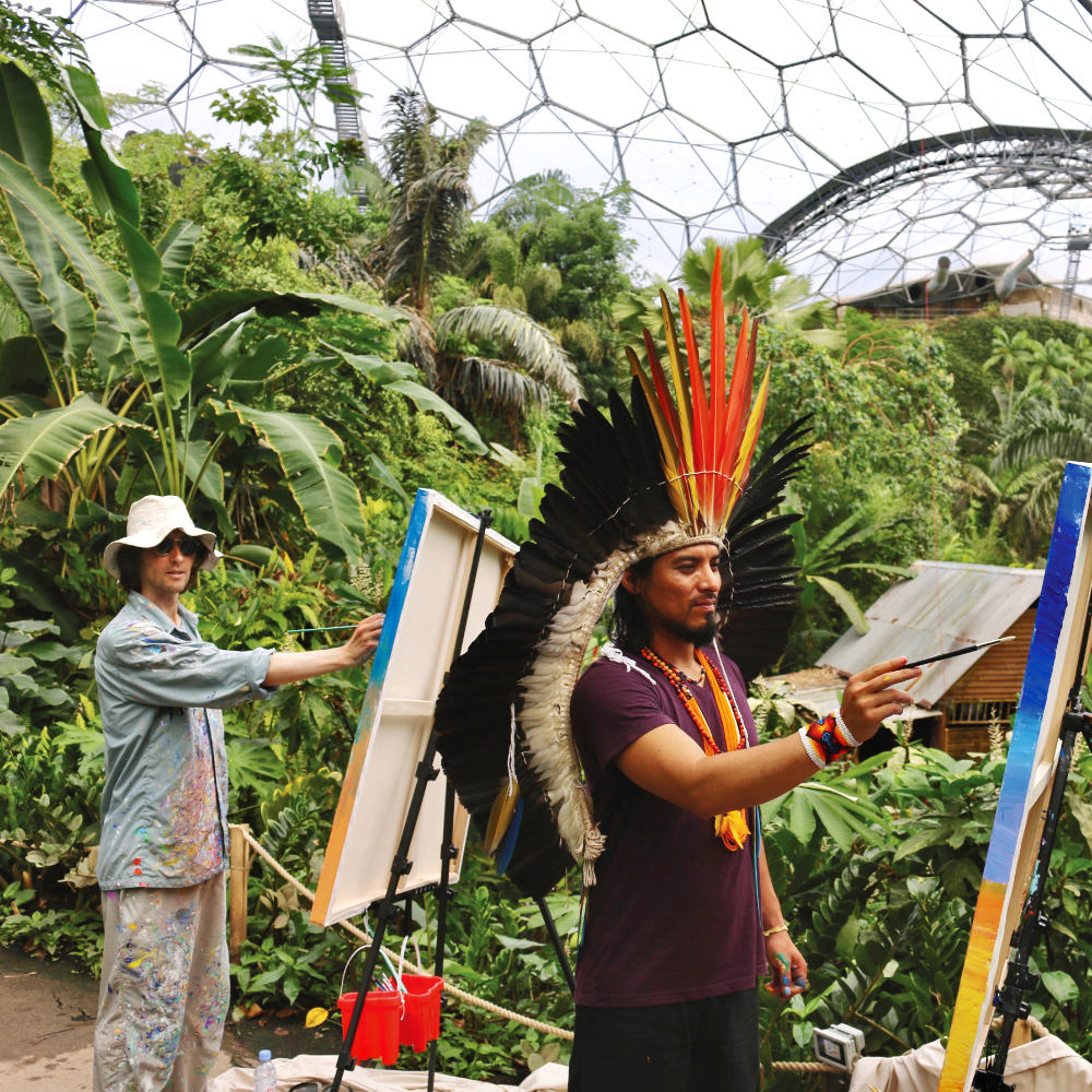 John Dyer and Nixiwaka Yawanawá painting in the rainforest biome of the Eden Project