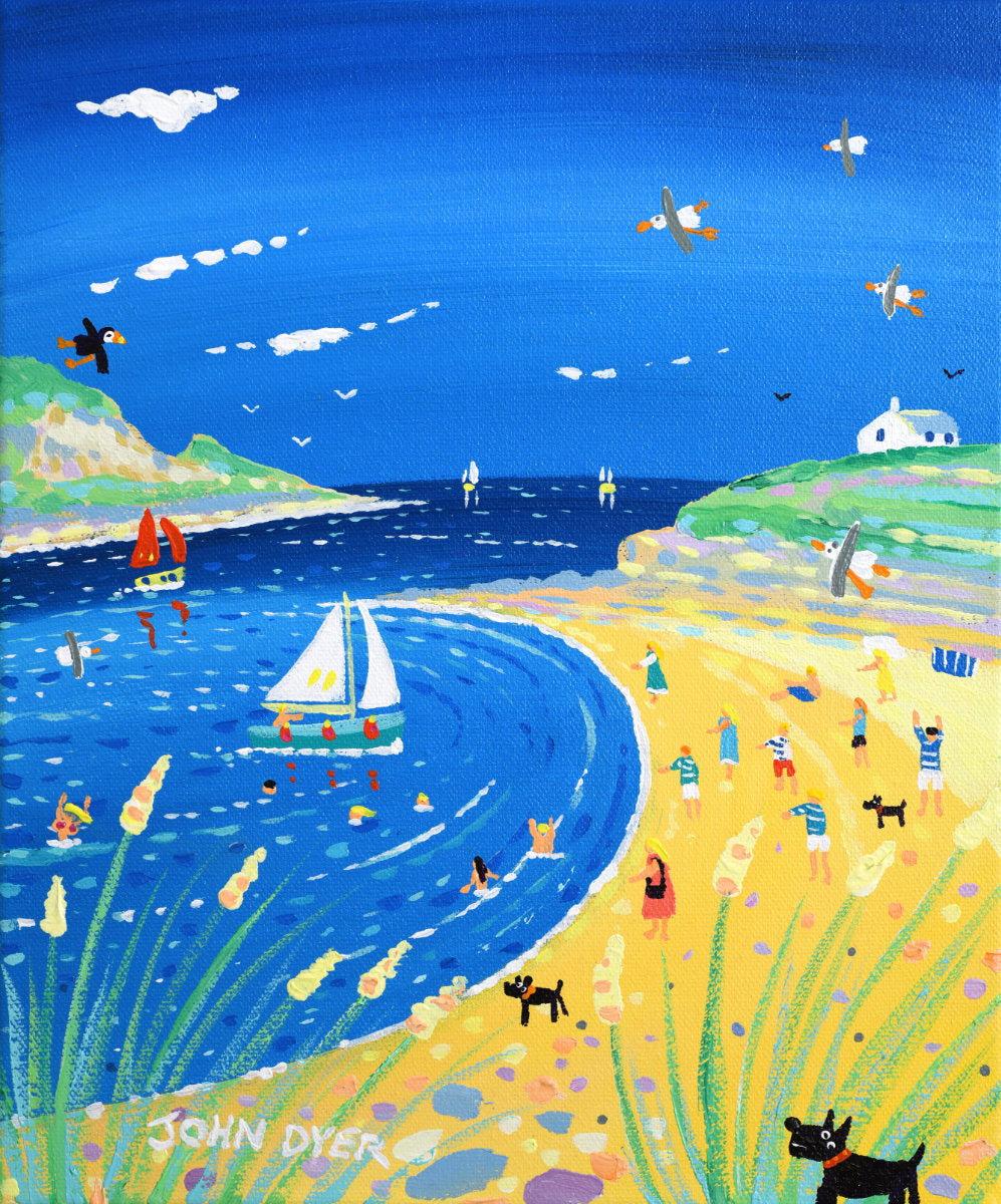 A colorful coastal landscape painting showing a sandy beach, deep blue water with sailboats, green cliffs, small figures of people, birds, and a white house. The artist's signature 'JOHN DYER' is visible in the lower left corner. 'Day on the Beach, Daymer Bay', 12 x10 inches acrylic on canvas by Cornish Artist John Dyer