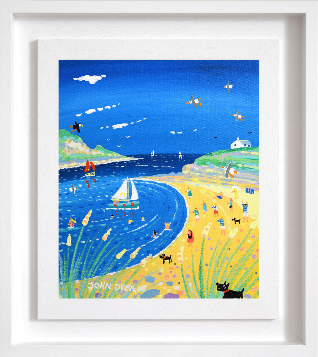 Framed coastal landscape art print showing a blue sea, sandy beach, green hills, and small illustrated figures and boats, presented in a white frame. 'Day on the Beach, Daymer Bay', 12 x10 inches acrylic on canvas by Cornish Artist John Dyer