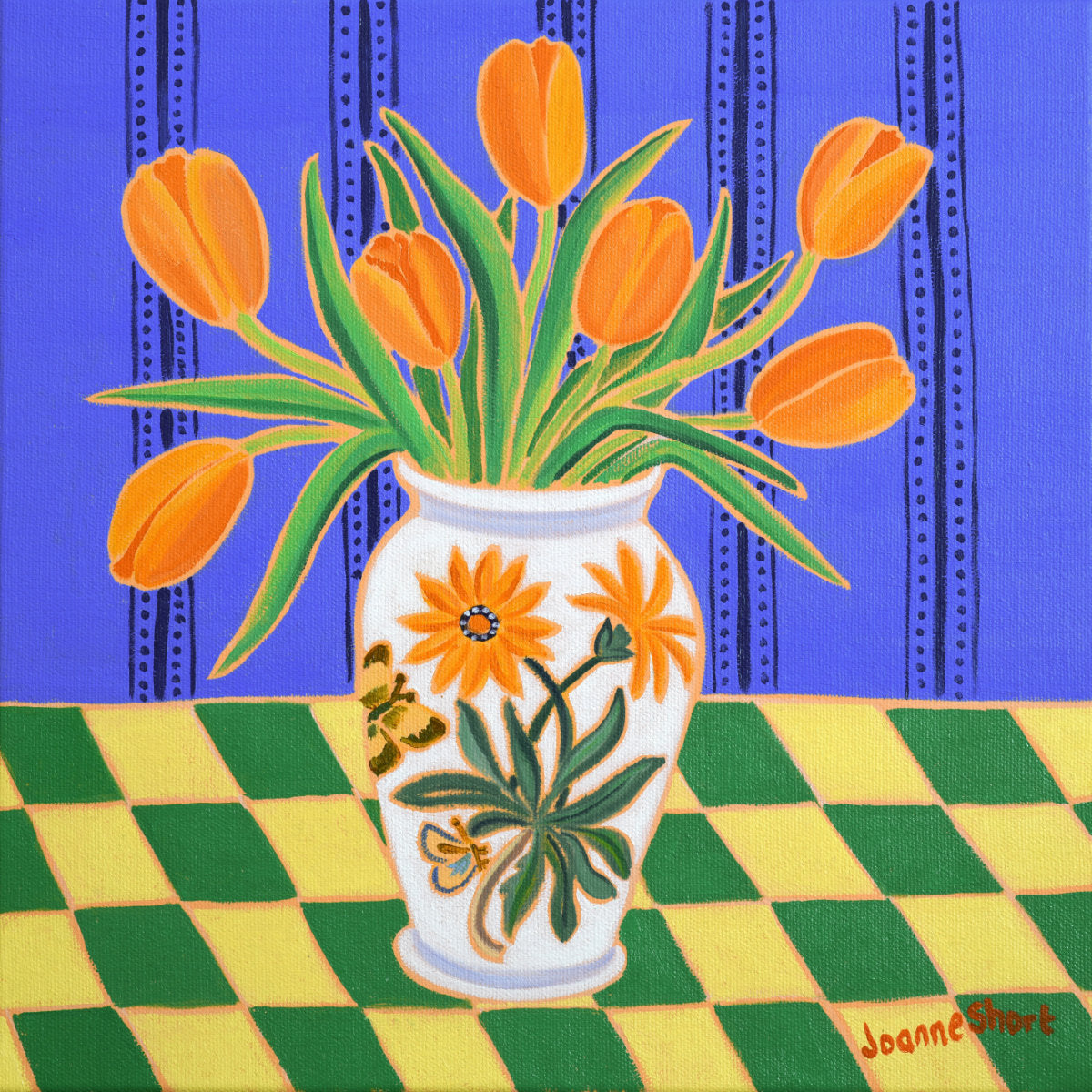 A colorful painting of orange tulips in a white floral vase, set on a green and yellow checkered table against a blue patterned background. The artist's signature 'Joanne Short' is visible in the bottom right corner. 'Orange Tulips in a Cornish Kitchen'. 12 x 12 inches Original Oil Painting on Canvas by Cornish Artist Joanne Short