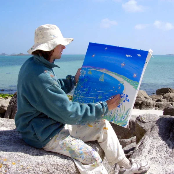 Cornish artist John Dyer seen painting the Cornish coast on the island of Tresco, Isles of Scilly.
