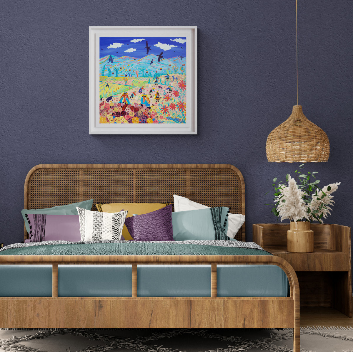 Bedroom with wooden bed, colorful pillows, and a painting on the wall. 'Andean Potato Pickers, Amaru, Peru'. 24x24 inches acrylic on canvas. Paintings of Peru by John Dyer from our Online Art Gallery