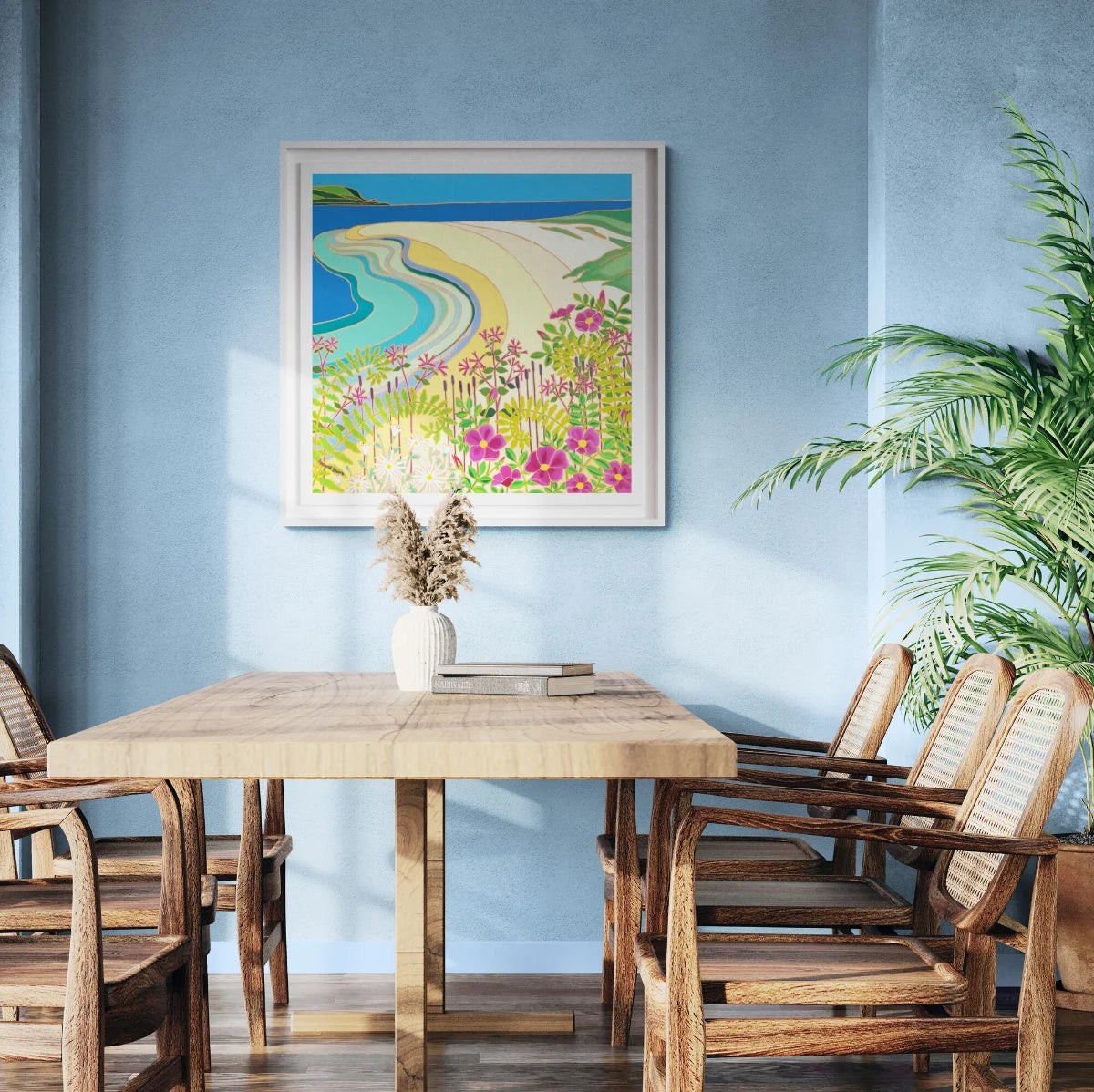 Dining room with wooden table and chairs, framed artwork on the wall, and a plant. 'Incoming Tide, Daymer Bay, The Camel Estuary', 30x30 inches oil on canvas. Original Painting by Cornish Artist Joanne Short