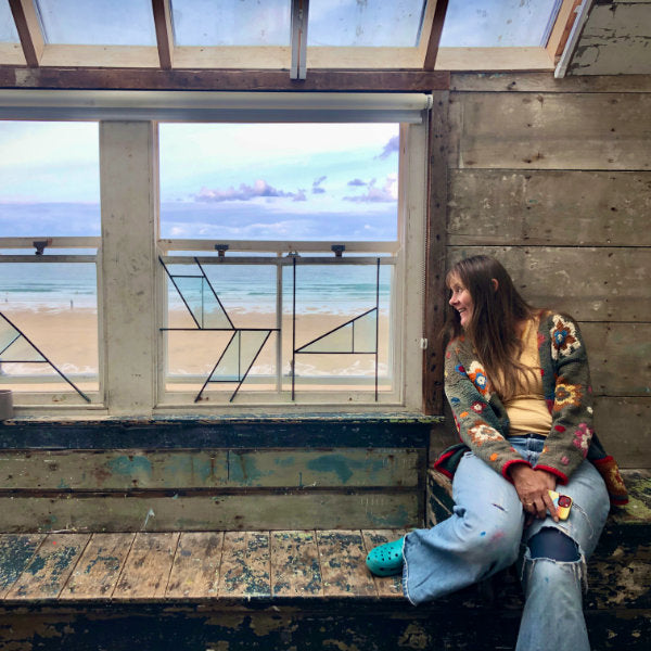 Cornish artist Joanne Short looking at the view of the sea from Porthemeao Art Studios in St Ives