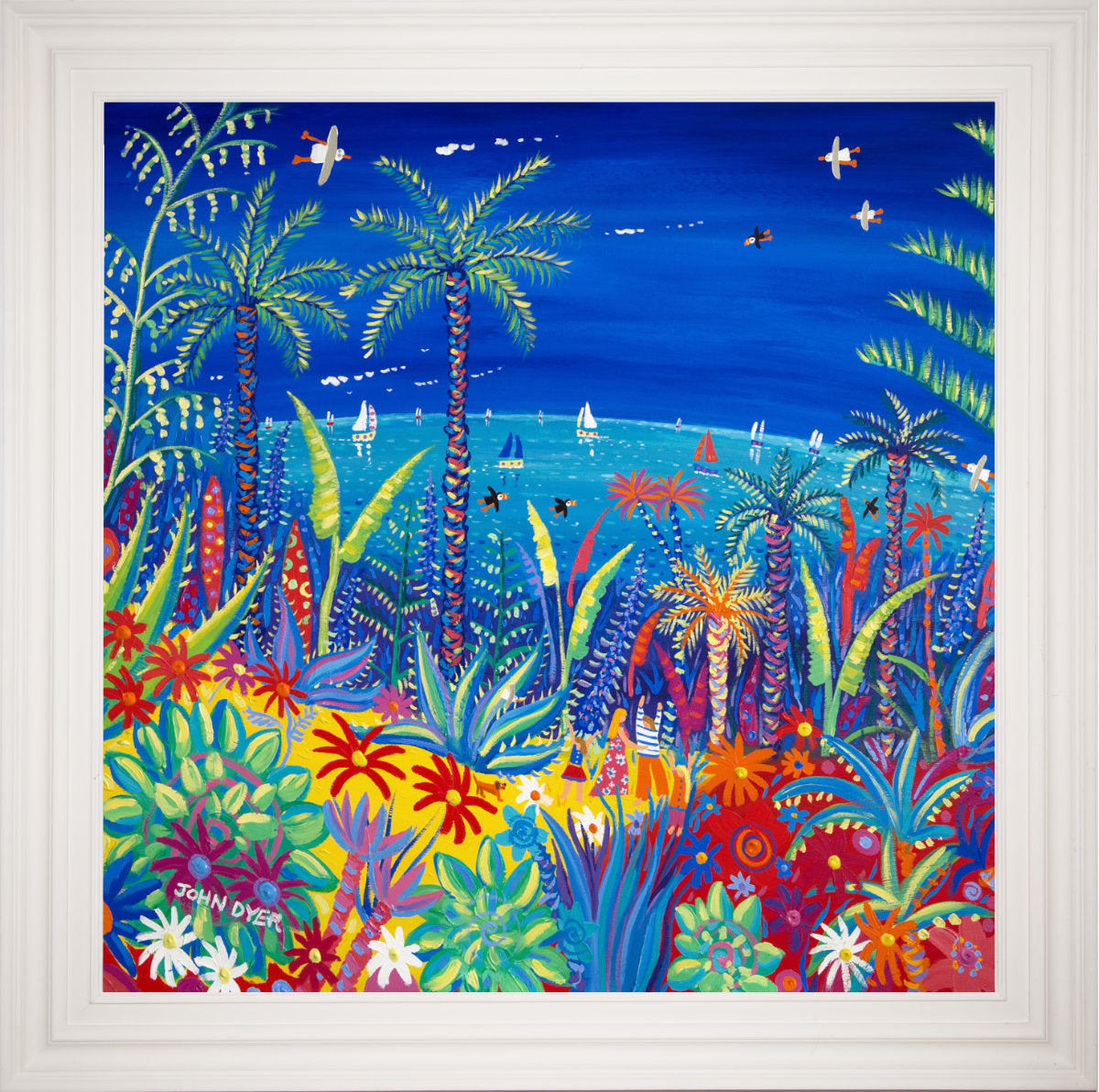 A colourful framed painting by John O'Brien depicting a tropical beach scene with palm trees, sailboats, and a vibrant blue sky, presented in a white frame. Original Painting by John Dyer. 'Painting the Colours of the World, Tresco.' 100x100cm acrylic on canvas