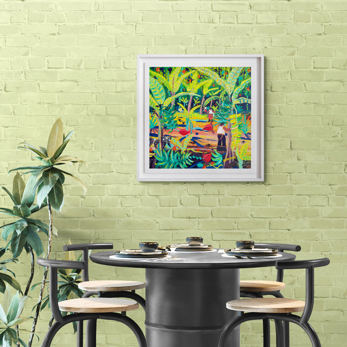Colorful abstract painting on a green brick wall above a black dining table. 'Jungle Bananas, Costa Rica', 24x24 inches acrylic on canvas. Tropical Costa Rica Painting by British Artist John Dyerwith chairs.