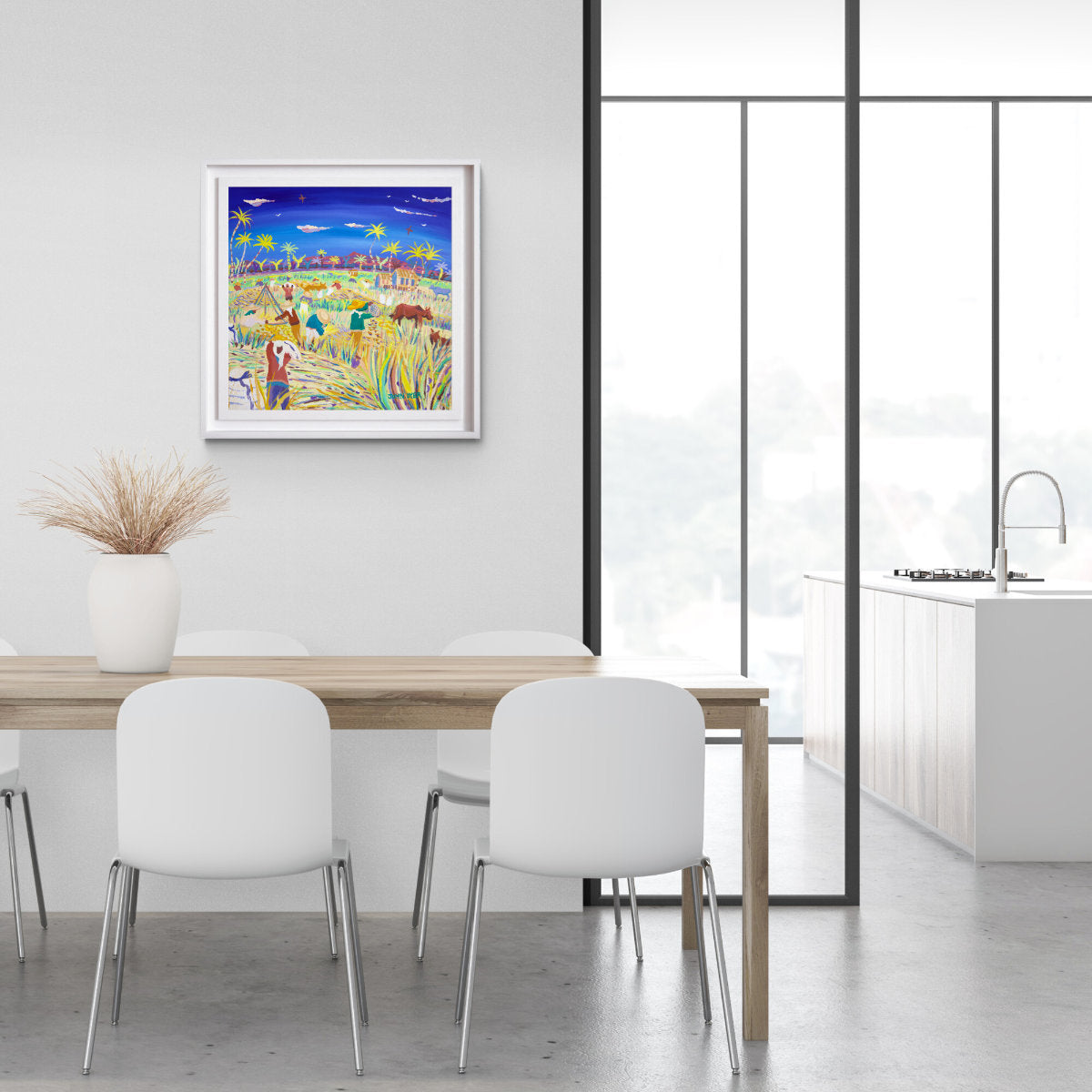 Colorful abstract painting on a wall above a dining table with white chairs. 'Winnowing in the Wind, the Philippines Rice Harvest'. 24x24 inches acrylic on canvas. Paintings of Philippines by John Dyer from our Online Art Gallery