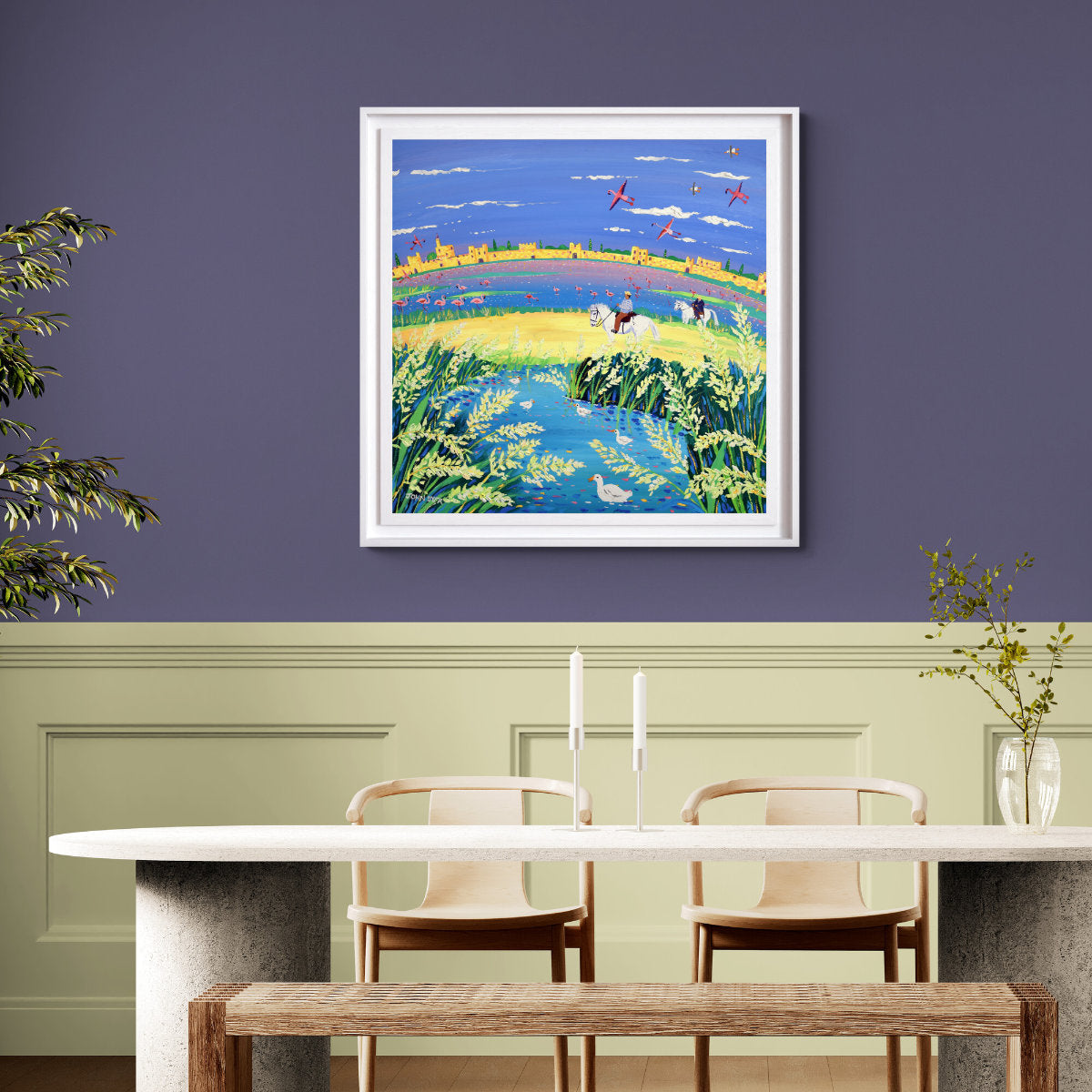 Dining room with a colorful framed painting on a purple wall, table, chairs, and plants. 'The Spirit of the Camargue, Rice and Flamingoes, Aigues-Mortes'. 35.5 x 35.5 inches acrylic on canvas. Painting of Provence, France by John Dyer