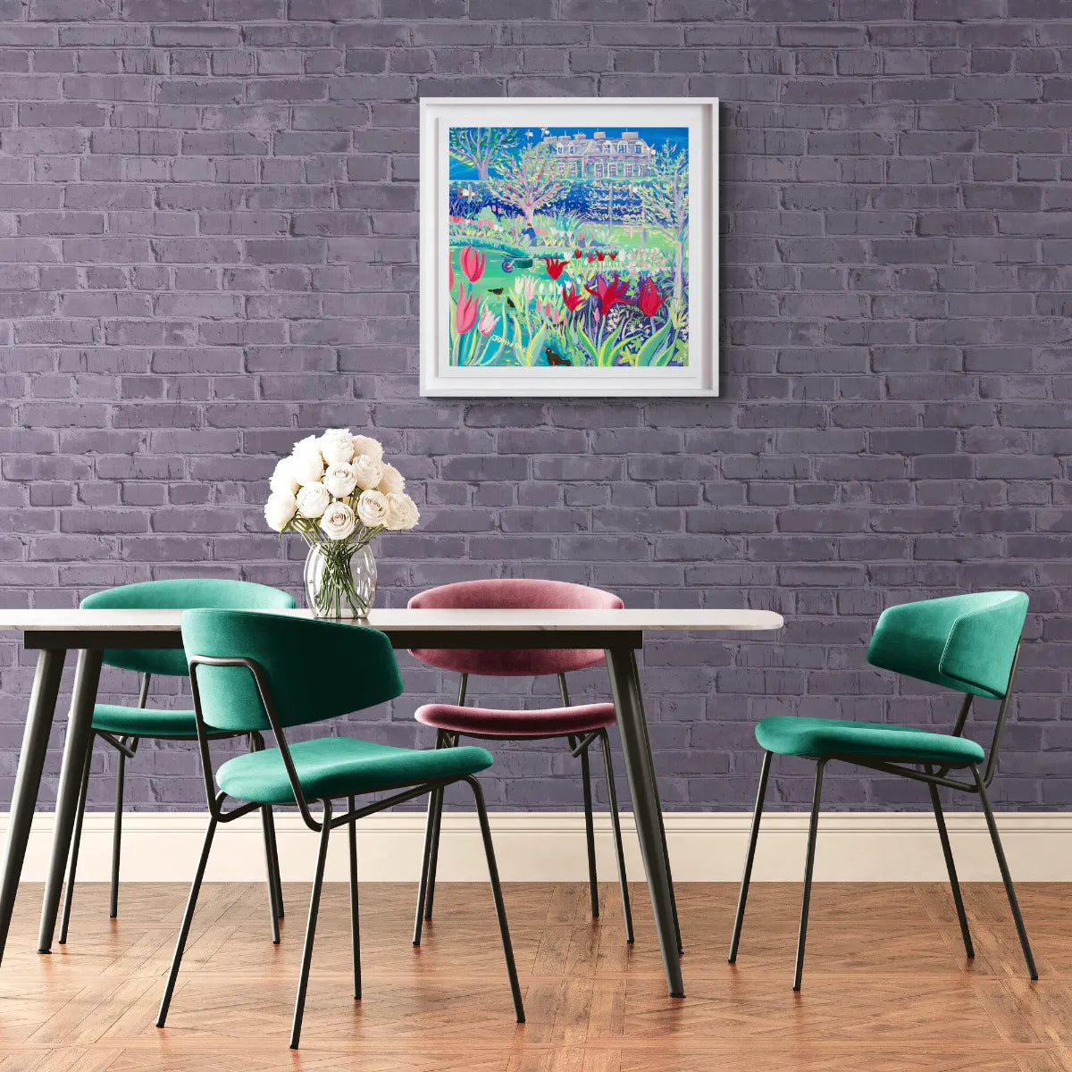 Dining room with a table and chairs against a purple brick wall with a colorful painting. 'The Flower Garden Antony House', 24x24 inches acrylic on canvas. Original Painting of Cornwall by Cornish Artist John Dyer