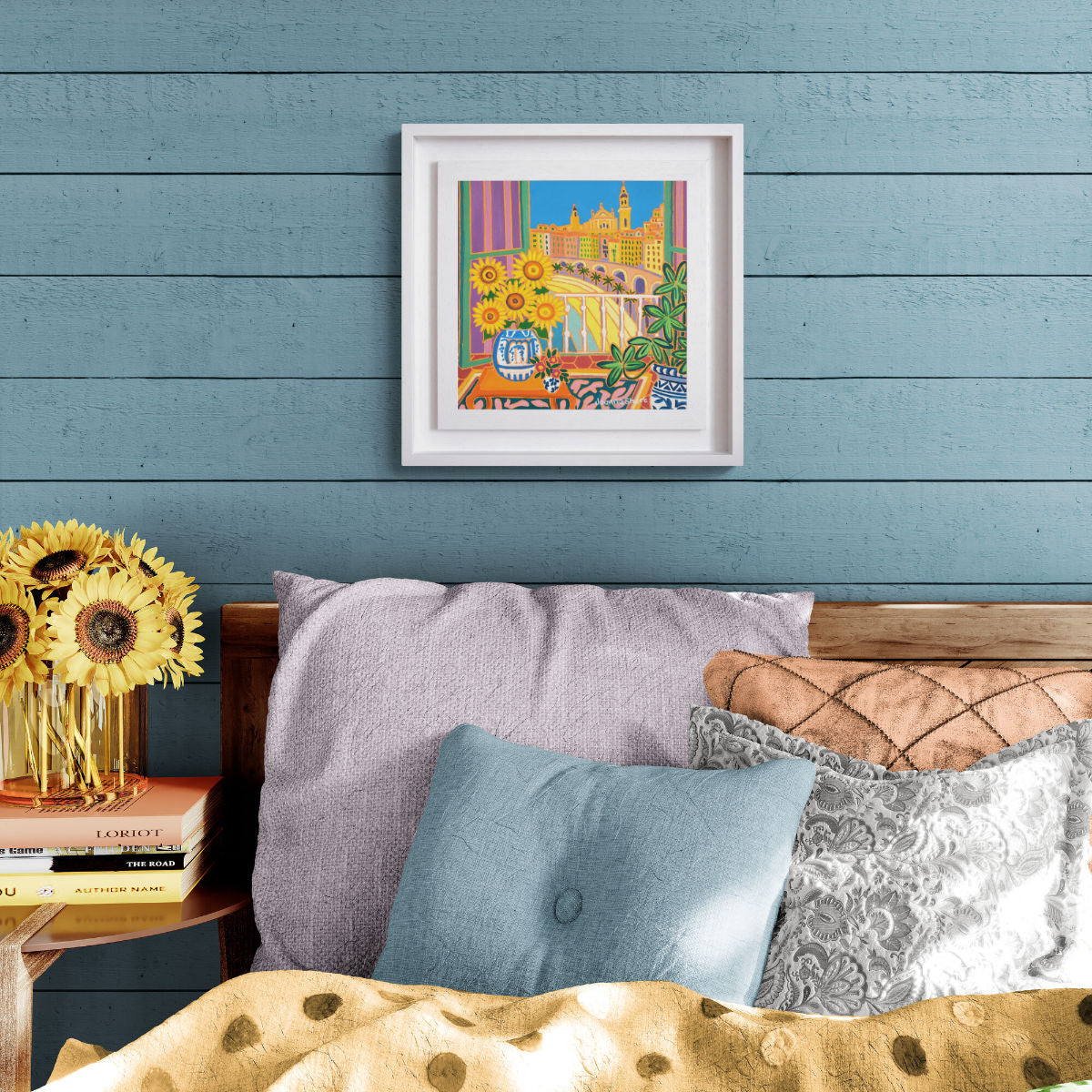 ‘Sunflowers in a Sunny Room, Menton, France’ painting by Joanne Short showing sunflowers in a French interior with balcony, Menton old town and palm-lined beach beyond.