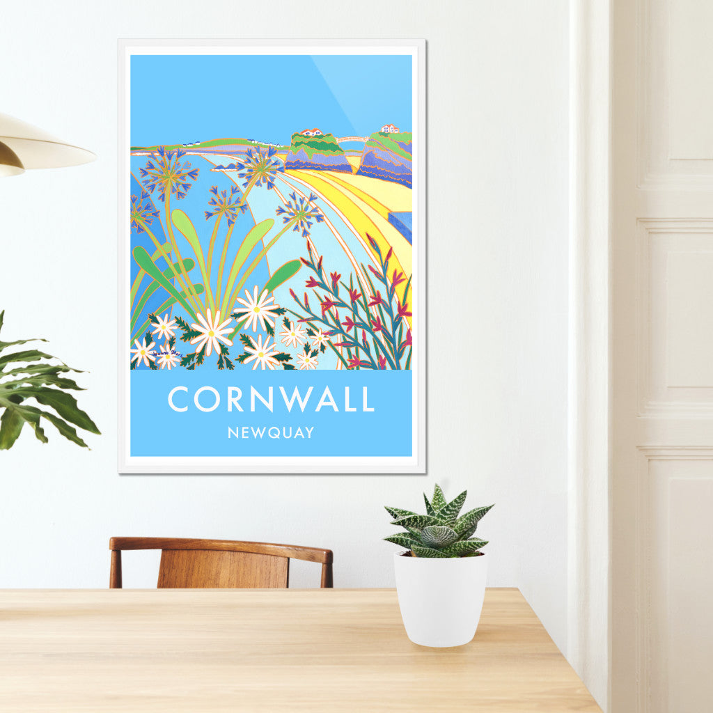 Cornwall framed wall art poster print of Newquay by Cornish artist Joanne Short. A fabulous vintage style art poster print of Newquay Towan Beach in Cornwall by artist Joanne Short. An amazing image with agapanthus and wild flowers looking back towards Towan Beach and the island with the suspension bridge.