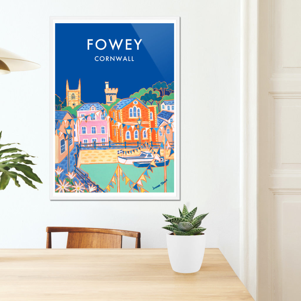Cornwall framed wall art poster print of Fowey by Cornish artist Joanne Short. This is a wonderful example of Cornish contemporary painting combined with classic 1930s style type to create a very special vintage style art travel poster of Fowey in Cornwall. A painting by acclaimed colourist painter Joanne Short is the main image on the poster print. A deep blue sky creates a dramatic backdrop to the colourful buildings, fishing boats and bunting of Fowey.