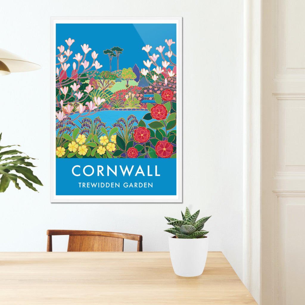 Cornwall wall art poster print of the Cornish garden of Trewidden near penzance by Cornish artist Joanne Short. Trewidden Garden near Penzance in Cornwall commissioned Joanne Short to create this stunning picture of the glorious spring flowers &amp; landscape that makes this garden so special. The Peter Veitch Magnolia tree flowers against the perfect Cornish blue sky. Camellias, primroses &amp; bluebells surround the pond &amp; our eye is drawn through the picture to the garden benches and the tranquility they evoke.