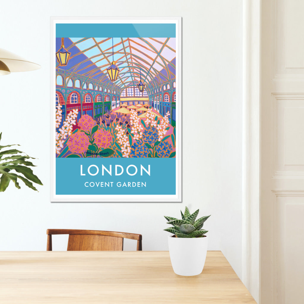 Framed London wall art poster print of the flower market at Covent Garden by British artist Joanne Short. This vintage style art poster of the Flower Market, Covent Garden by artist Joanne Short is absolutely delightful and a perfect way to celebrate London in style. The artist has captured the architecture perfectly and her flat use of colour really helps to create the space and form in this piece. A3, A2, A1 and 70x100cm sizes.
