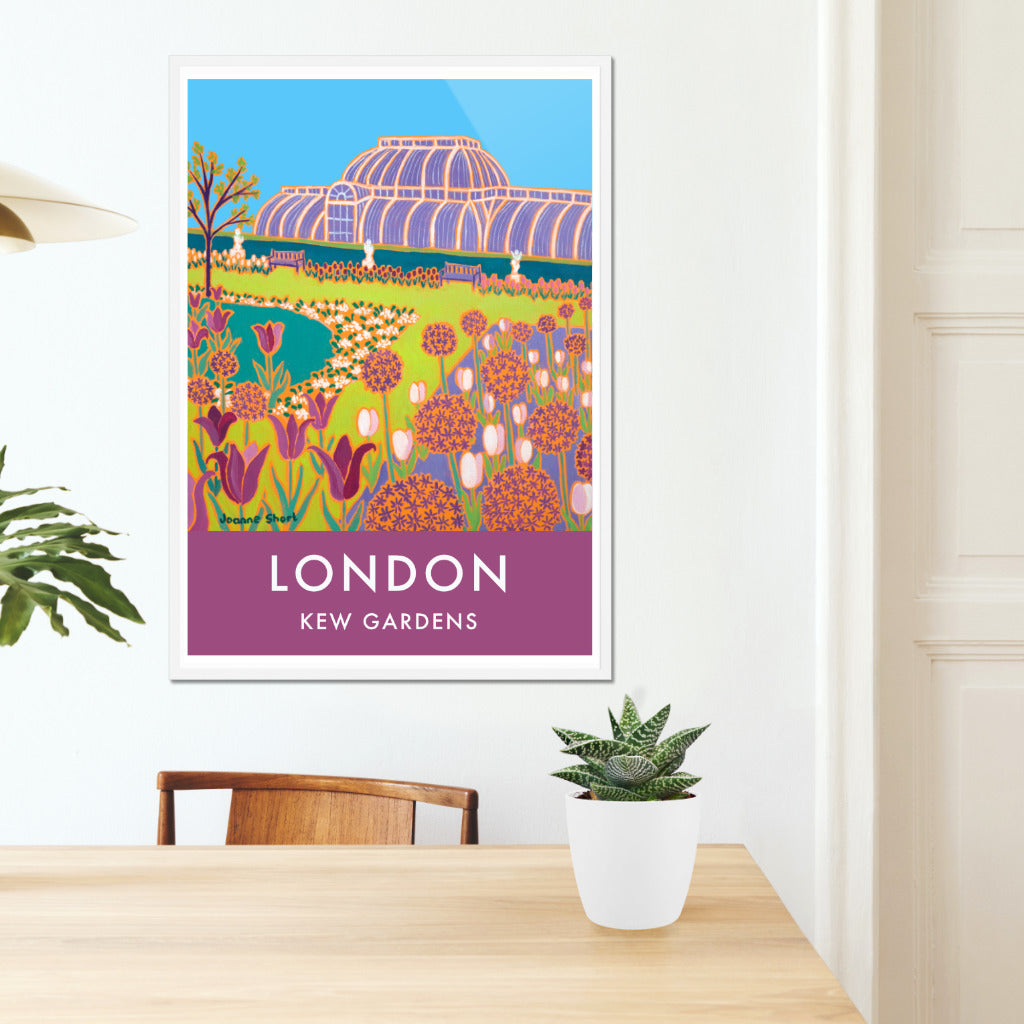 Framed London wall art poster print of Kew Gardens and the glass house by British artist Joanne Short. &#39;Spring Flowers, Kew Gardens&#39;, an oil painting by artist Joanne Short, is featured on this vintage style travel art travel poster of Kew gardens in London. Her brilliant use of line and colour create a really stunning image which is filled with spring flowering bulbs. The famous glass house at Kew dominates the skyline and our eye is led to the glasshouse along a perfectly mowed grass pathway.