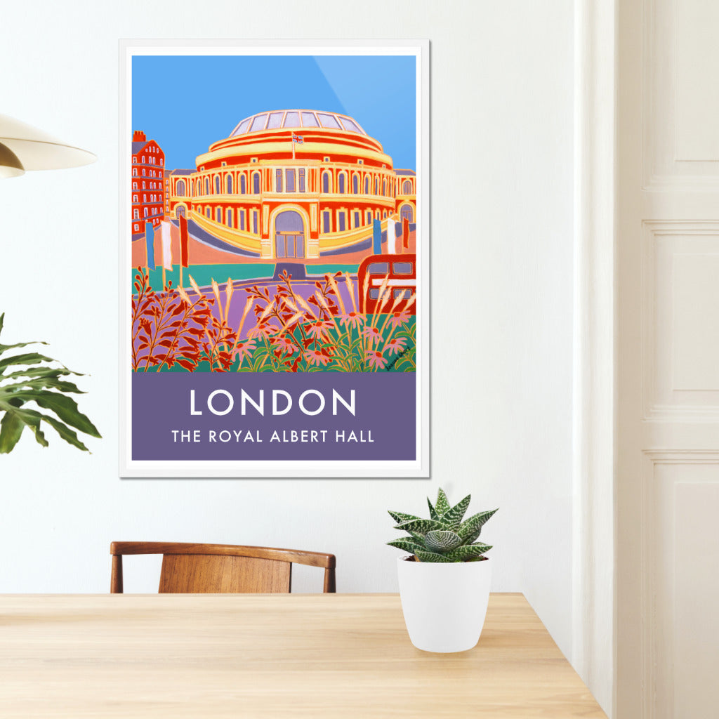 Framed archival London wall art poster print of the Royal Albert Hall from Hyde park by British artist Joanne Short. &#39;Flowers and Flags, The Royal Albert Hall&#39; is the title of the Joanne Short painting featured on this stunning London art poster. The view is from Hyde Park looking back towards the amazing form and colour of the Royal Albert Hall. A red London bus can be seen on the right of the picture and red, white and blue flags flutter in the breeze. A celebration of London, music and culture.