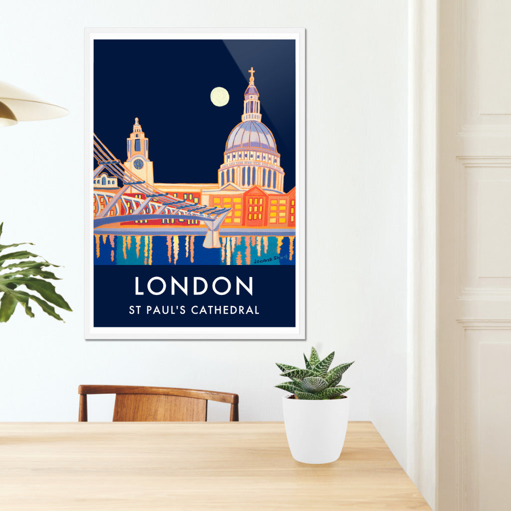 Framed London wall art poster print of St Paul&#39;s Cathedral at night by British artist Joanne Short. We think this is possibly one of the best ever London vintage style travel art posters. Joanne Short&#39;s painting &#39;Full Moon over St Paul&#39;s Cathedral&#39; is remarkable in so many ways and creates a fabulous travel poster of London. A full moon illuminates St Paul&#39;s Cathedral and the London skyline &amp; everything is reflected in the River Thames. Vintage style typography completes the look of this piece.