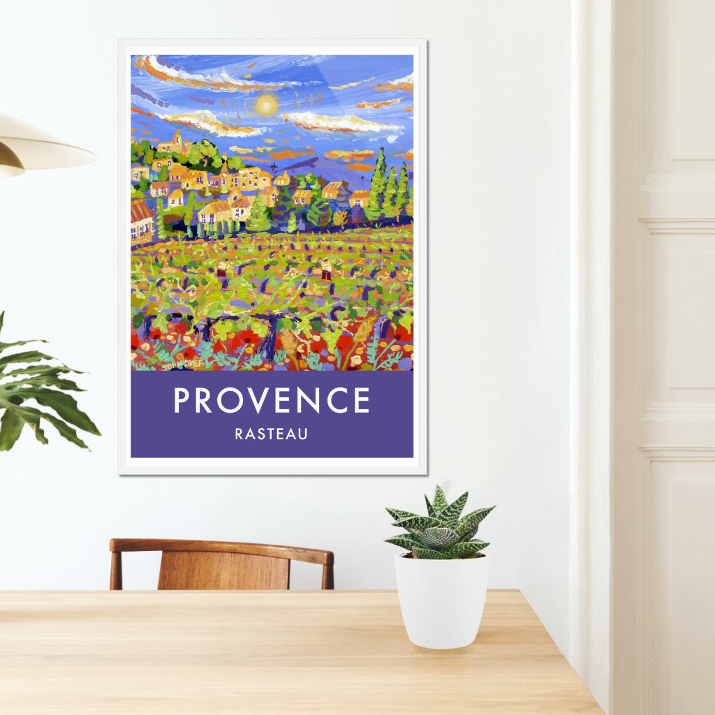 Provence wall art poster print available unframed or framed. The spring colours of the vineyards surrounding the wine producing village of Rasteau in Provence have been captured perfectly by British artist John Dyer. John often paints in Provence and stays in a farmhouse in the village. This vintage style art travel poster features John&#39;s painting &#39;The Sun sets over the new Vines, Rasteau&#39; which was painted en plein air in Provence.