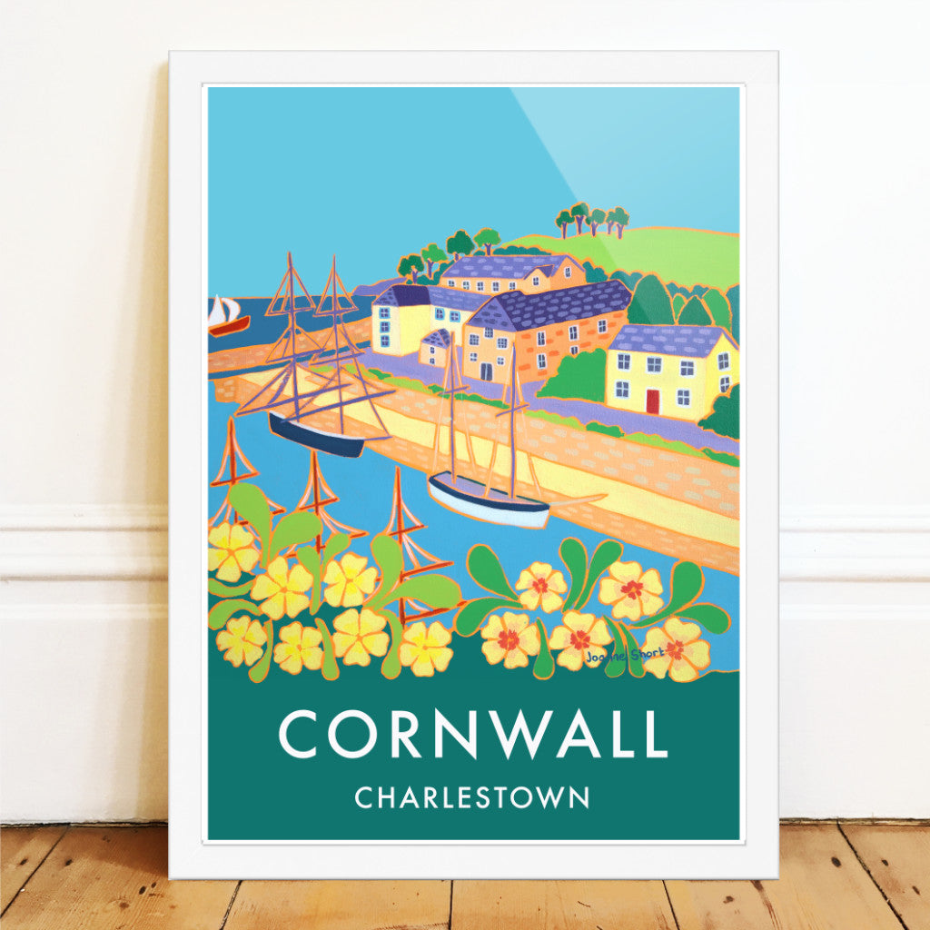 Cornwall wall art poster print of the harbour of Charlestown by Cornish artist Joanne Short. The Georgian working port of Charlestown in Cornwall, that is now often home to Tall Ships &amp; film crews such as Poldark &amp; Mansfield Park, has been painted for this vintage style travel poster by Cornish artist Joanne Short. Primroses jostle for space in the foreground. We look through the masts of a ship to the tall ships beyond that are waiting alongside the quay.