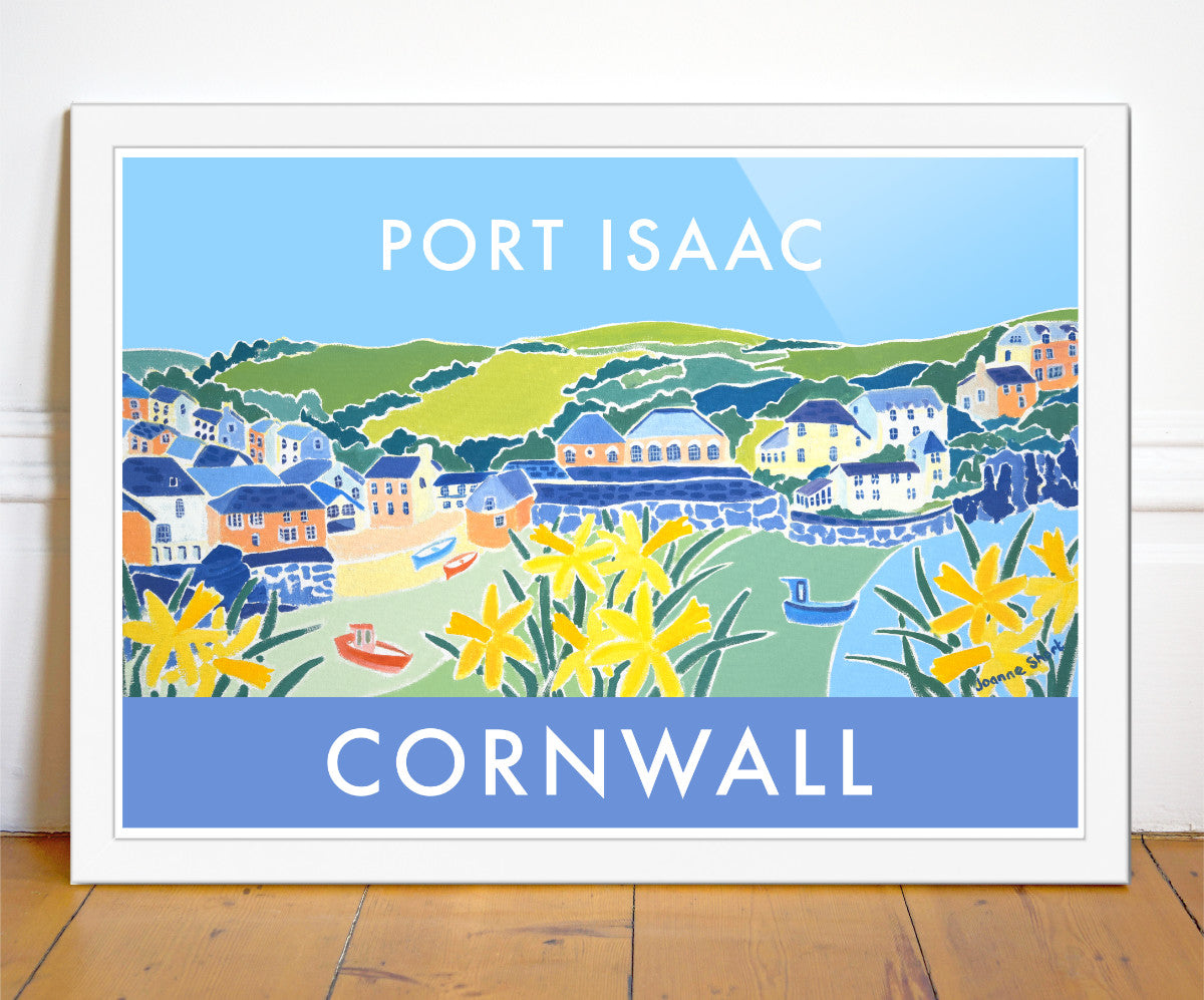 Port Isaac in Cornwall is captured by artist Joanne Short in this stunning travel wall art poster print. Daffodils line the harbour wall &amp; bands of colour sweep into the bay as the tide rises. Colourful fishing boats dot the shoreline and the Cornish cottages cling to the cliff side. A magical image of this special harbour village. Port Isaac is famously featured in the &#39;Doc Martin&#39; TV series as &#39;Portwenn&#39;.