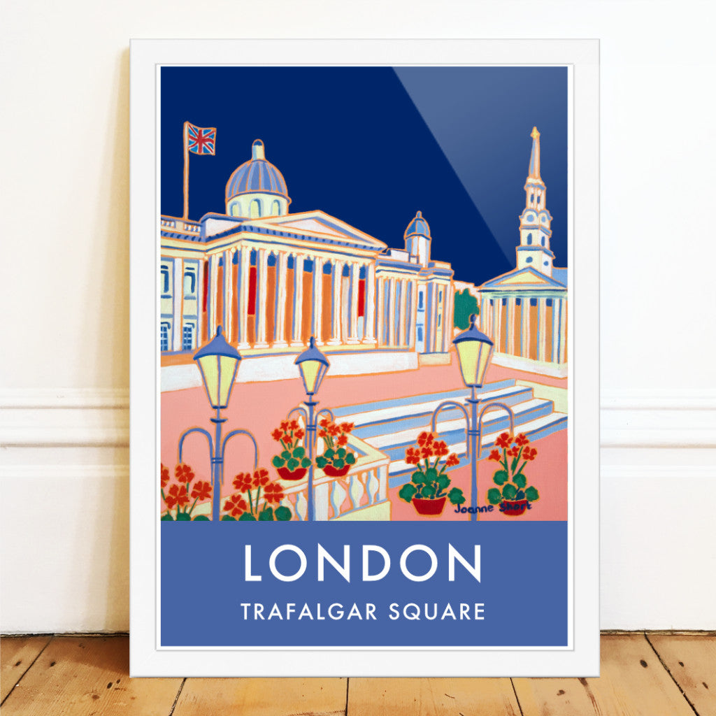 London wall art poster print of Trafalgar Square and the National Gallery by British artist Joanne Short. A stunning vintage style travel poster featuring Joanne Short&#39;s painting &#39;Blue Sky, Trafalgar Square&#39;. A union jack flag flutters above the National Gallery set against a midnight blue sky. The church of St Martin-in-the-Fields also features in the poster set back beyond the classic London street lights. Red geraniums complete this delightful composition. A perfect London art poster