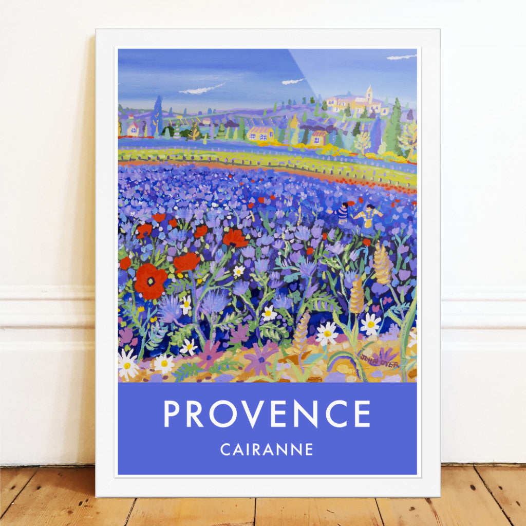 Vintage style travel art poster print of Provence in France featuring the art of John Dyer and the village of Cairanne in the Vaucluse region of Provence in the South of France. John has captured the amazing sight of a field of blue flowers and poppies set against the landscape of Provence and the wine producing village of Cairanne.