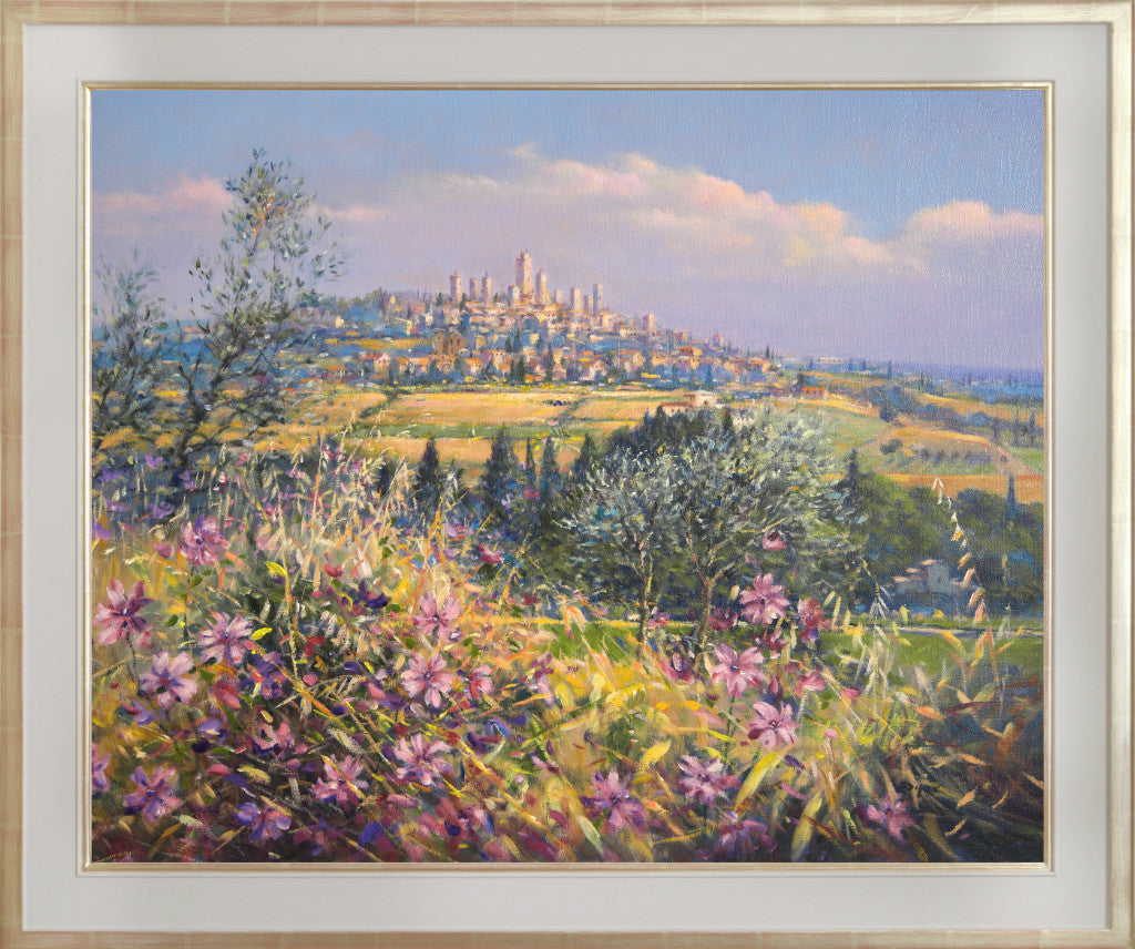 The painting brings the light, colours and textures of Italy to all who view. Wild flowers fill the foreground of the canvas and olive trees and pencil pines create a stage for the spectacular vista of the village of San Gimignano beyond. This painting is one that will bring the best of Tuscany and the best of Ted Dyer's art into your home. Perfect.