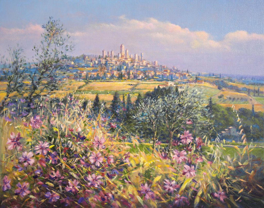 The painting brings the light, colours and textures of Italy to all who view. Wild flowers fill the foreground of the canvas and olive trees and pencil pines create a stage for the spectacular vista of the village of San Gimignano beyond. This painting is one that will bring the best of Tuscany and the best of Ted Dyer&#39;s art into your home. Perfect.